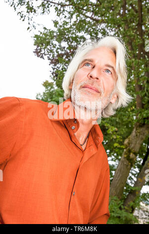 elderly man with grey long hair in nature, Germany Stock Photo