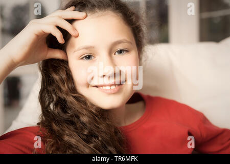portrait of a young girl in red pullover, Germany Stock Photo