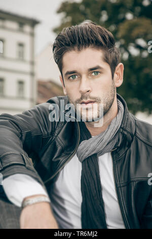 young attractive man with leather jacket in the city, Germany Stock Photo