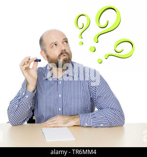 thinkful man in chequered shirt and three question marks, Germany Stock Photo