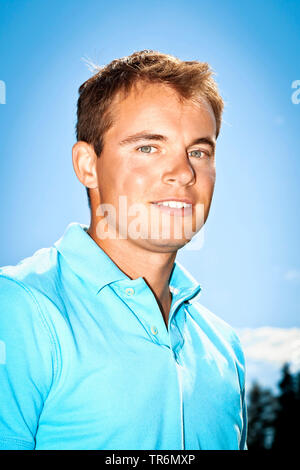 handsome young man in front of the blue sky, Germany Stock Photo