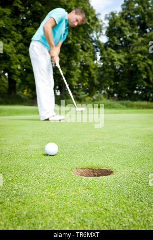 young man playing golf, Germany Stock Photo