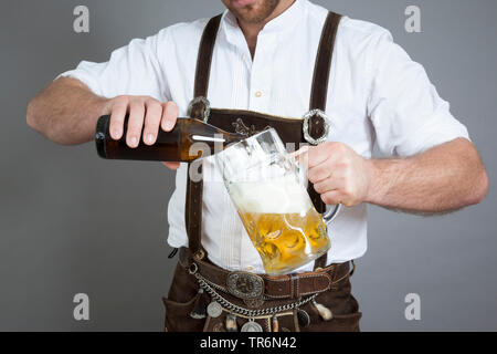 traditional bavarian man drinking mass beer, Germany, Bavaria Stock Photo
