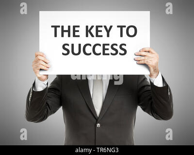 businessman holding a sign with the inscription The Key to Success, Germany Stock Photo