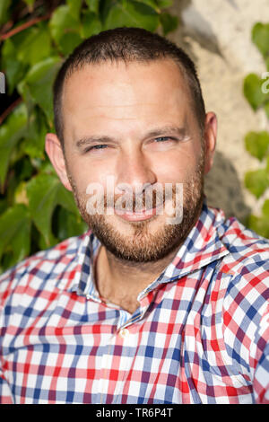 portrait of an handsome man with checkered skirt, Germany Stock Photo