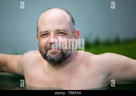 man relaxing in the pool, Germany Stock Photo