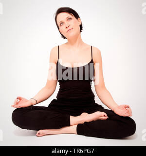 woman doing yoga at home, Germany Stock Photo