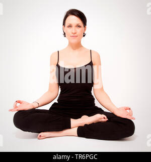 woman doing yoga at home, Germany Stock Photo