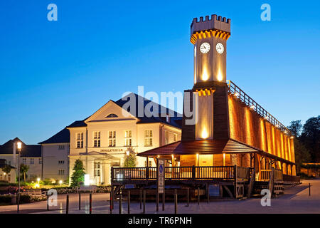 illuminated gradutation works with clock tower in the evening, Germany, North Rhine-Westphalia, East Westphalia, Bad Salzuflen Stock Photo