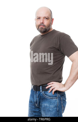 man with beard and bald head standing confidently with hands on hips, Germany Stock Photo