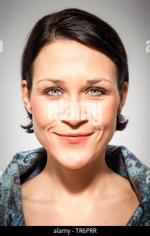 portrait of a young, good looking woman with black short hair Stock Photo