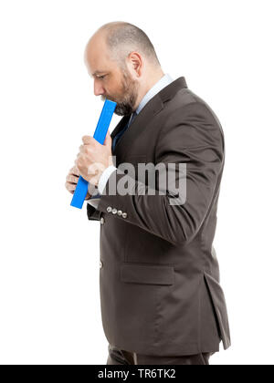 Middle-aged businessmann thinking about solutions and holding folder, Germany Stock Photo