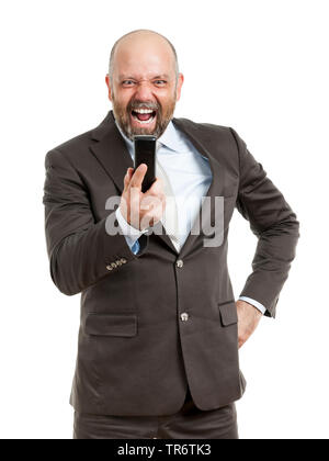 Middle-aged businessmann, shouting at his mobile phone, Germany Stock Photo