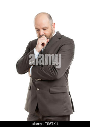 Middle-aged businessmann reflecting with hand touching his face, Germany Stock Photo