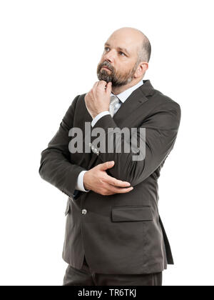 Middle-aged businessmann reflecting with hand touching his chin, Germany Stock Photo