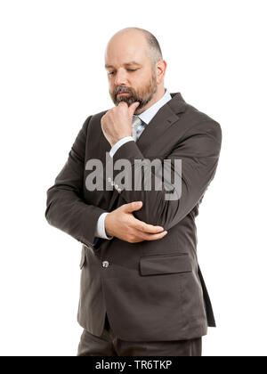 Middle-aged businessmann reflecting with hand touching his chin, Germany Stock Photo