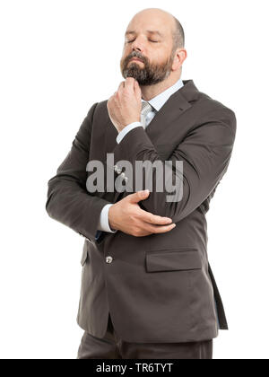 Middle-aged businessmann reflecting with hand touching his chin, Germany Stock Photo