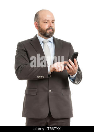 Middle-aged businessmann standing, using his mobile phone, Germany Stock Photo