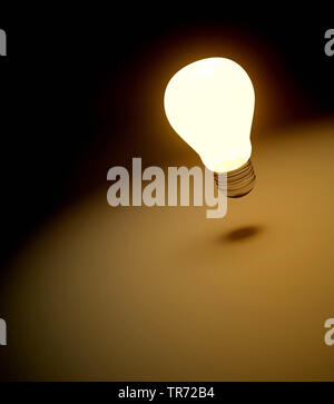 3D computer graphic, symbolic glowing lightbulb in the dark Stock Photo