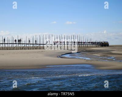 People walking on old landing stage to ferry at Vliehor, Netherlands, Frisia, Vlieland Stock Photo