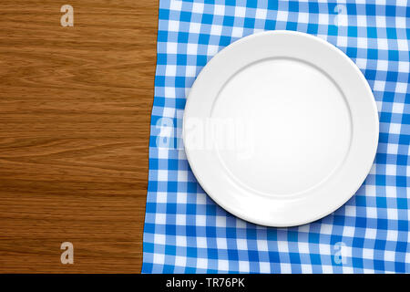 empty plate on a white-blue chequered tablecloth, Germany, Bavaria Stock Photo