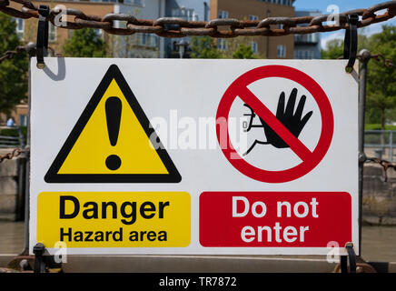 No-Go Zone” warning sign over grungy white and red old rusty road