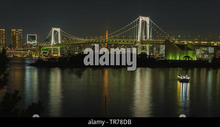 Iconic view from Odaiba on Reinbow Bridge and Tokyo Tower in illuminated City centre of japans capital at evening, October 2018 Stock Photo