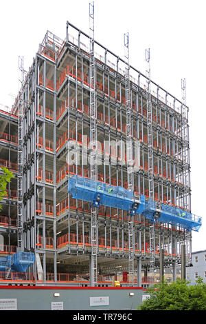 Electric Mast climbing Access Platforms In Use For The Cladding Of A electric-mast-climbing-access-platforms-in-use-for-the-cladding-of-a