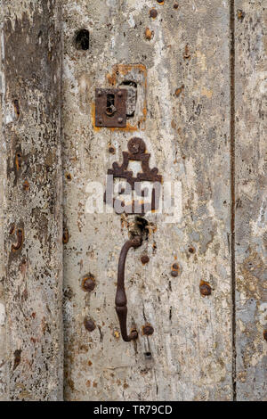 Old elegant door furniture on wooden door Stock Photo