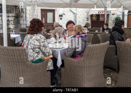 Montenegro, April 30th 2019: Cafe terrace with guests in the Old Town of Kotor Stock Photo