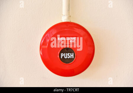 Fire alarm switch press button push for bell warning fire equipment on wall building Stock Photo