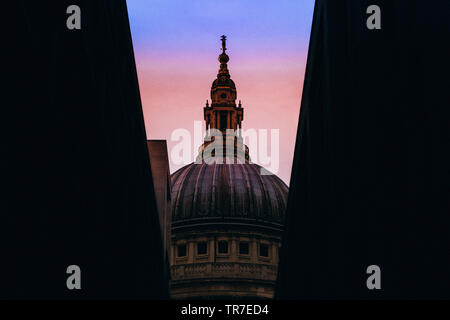 St. Paul's Cathedral between buildings at sunset, London, England