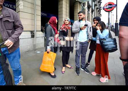 London, England, UK. Muslim family outside Westminster tube station Stock Photo