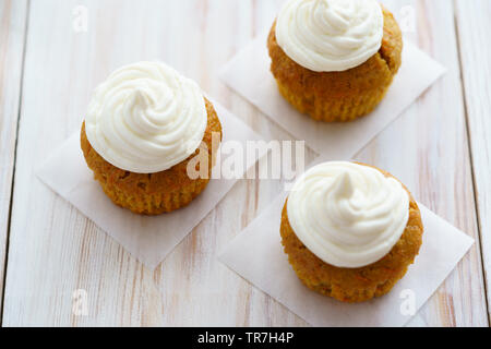 Carrot cupcakes with vanilla frosting. White wooden table, high resolution Stock Photo