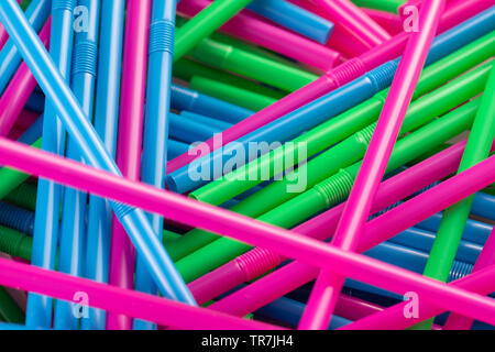Pile of multicoloured plastic drink straws ideal for a background. Shows concept of plastic waste and the ban on plastic drinking straws Stock Photo