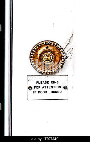 Old door bell needing polishing Stock Photo