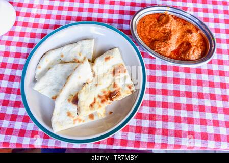 Top View of Chicken Tikka Masala with Indian Style Naan Breads Stock Photo