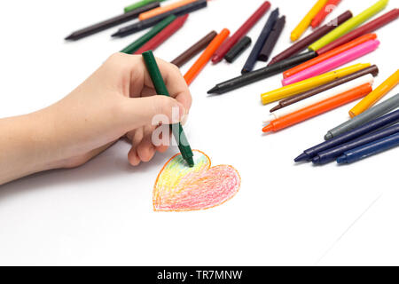 Top view of baby's hand drawing with green pencil on white paper with the  set of colour pencils. Kids painting concept. Copy space for text. Mockup  Stock Photo - Alamy