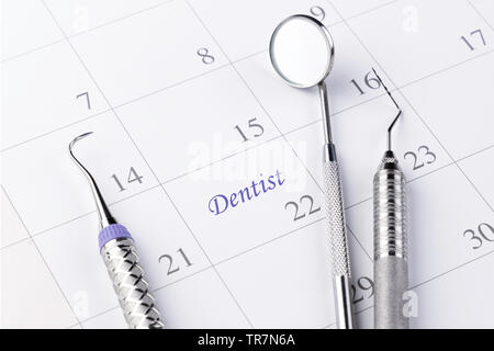 Reminder dentist appointment in calendar and professional dental tools.- Image Stock Photo
