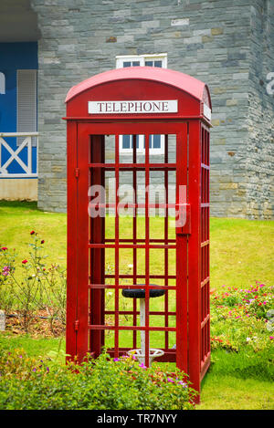 Old english red callbox vintage box of telephone traditional in the park garden Stock Photo