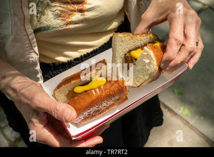 A foodie with her lunch of Beyond Meat brand Beyond Sausage at a promotional event in New York on Thursday, May 24, 2019. The plant-based protein start-up Beyond Meat recently had its initial public offering. (© Richard B. Levine) Stock Photo