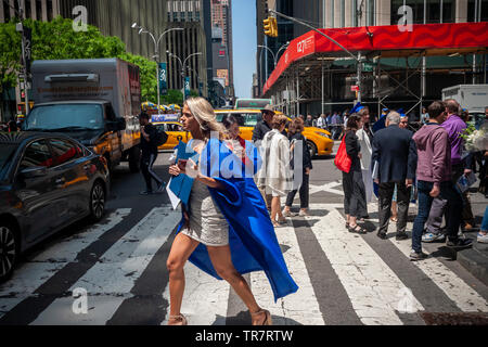 Very recent graduates from the Fashion Institute of Technology with their friends and families outside of Radio City Music Hall in New York on Wednesday, May 22, 2019 after the college's commencement exercises.  (© Richard B. Levine) Stock Photo