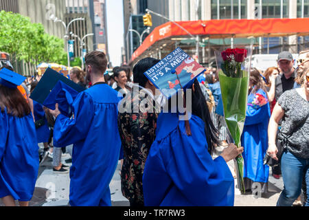 Very recent graduates from the Fashion Institute of Technology with their friends and families outside of Radio City Music Hall in New York on Wednesday, May 22, 2019 after the college's commencement exercises.  (© Richard B. Levine) Stock Photo