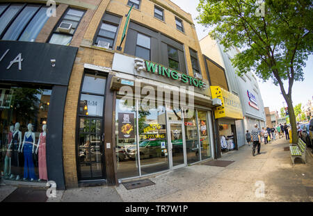 WingStop fast food on busy Steinway Street in the Astoria neighborhood of Queens in New York on Monday, May 27, 2019. ( © Richard B. Levine) Stock Photo