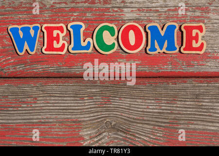 word welcome made of wooden letters on old wooden board Stock Photo