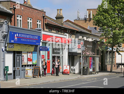 The newly refurbished East Dulwich Post Office on Lordship Lane, south London. Shows small shops on either side in this busy local high street. Stock Photo