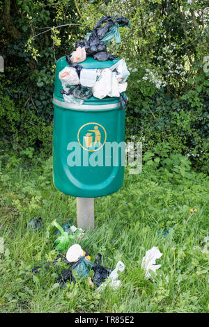 Overflowing litter bins in the countryside, England UK Stock Photo