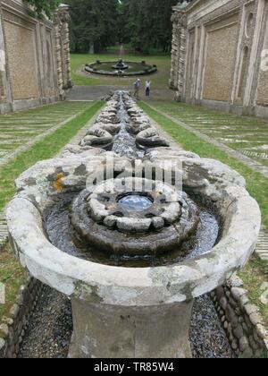 The gardens of the Villa Farnese feature ornate stonework and statues, and water features including fountains and a steeply inclined rill. Stock Photo