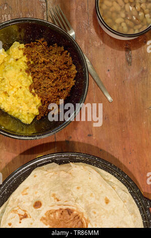 Mexico breakfast, machaca from Sonora with eggs, beans and flour tortillas. For restaurant, food blog, Mexican food. Copy space. Stock Photo