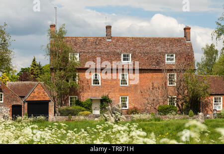 A large red brick house in The High Street, Avebury, Wiltshire, England, UK Stock Photo
